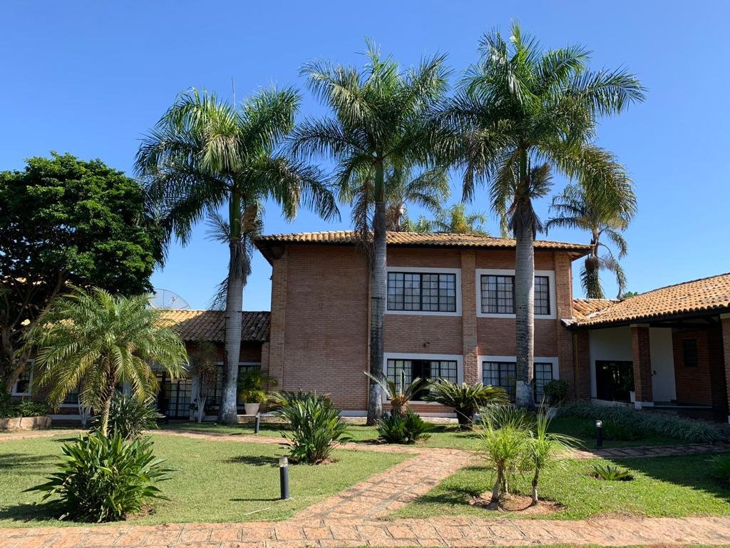 Fachada frontal da casa com palmeiras e alameda de paver
